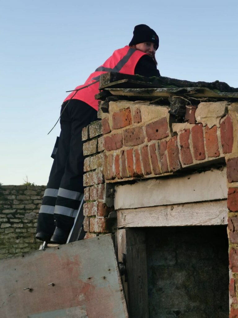 WP Group driver climbing a ladder to reach fuel tank